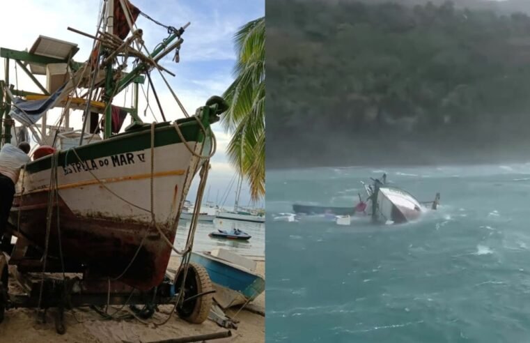 Barco de pescador é retirado do mar em Ilhabela